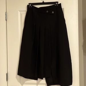 Zara high-waisted black asymmetrical midi skirt with pockets and a back slit.